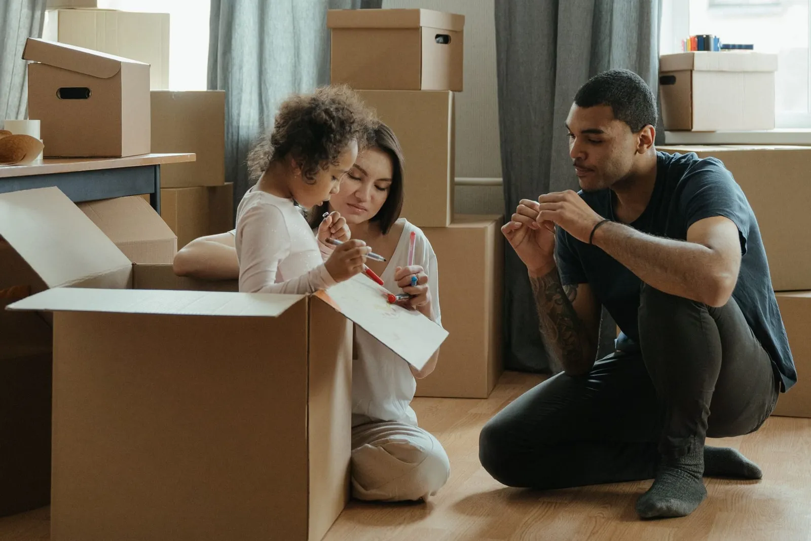 Family unpacking boxes after moving into a new home