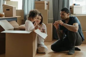 Family unpacking boxes after moving into a new home